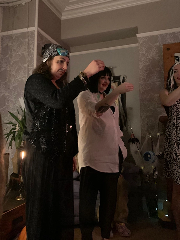 a group of friends using pendulum at a home psychic party